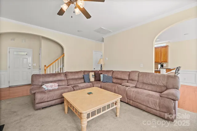 a living room with furniture and a chandelier