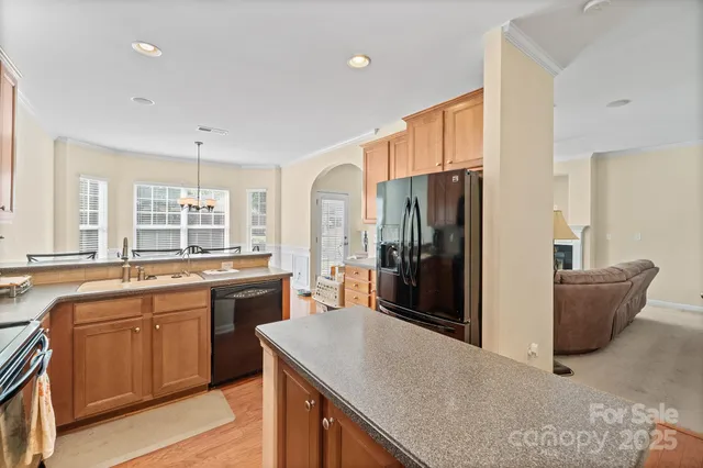 a kitchen with stainless steel appliances granite countertop a sink stove and refrigerator