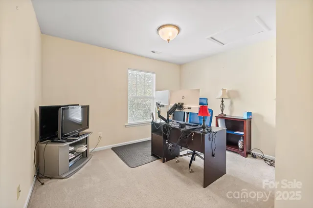 a workspace with furniture and a flat screen tv