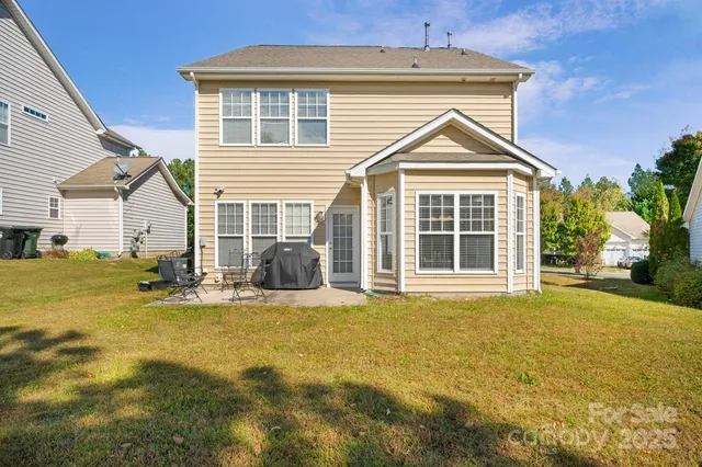 a view of a house with a yard and sitting area