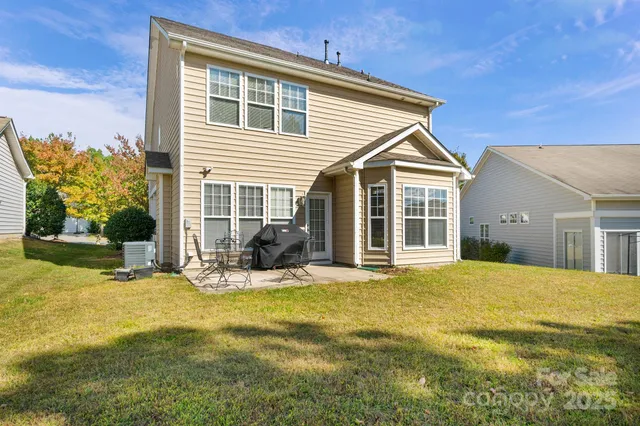 a view of a house with a yard and sitting area