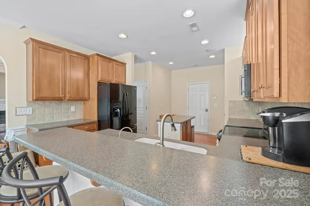 a kitchen with stainless steel appliances granite countertop a sink and cabinets