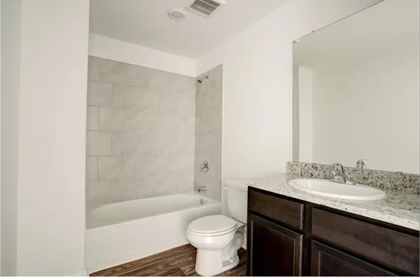 a bathroom with a sink a toilet and a bathtub