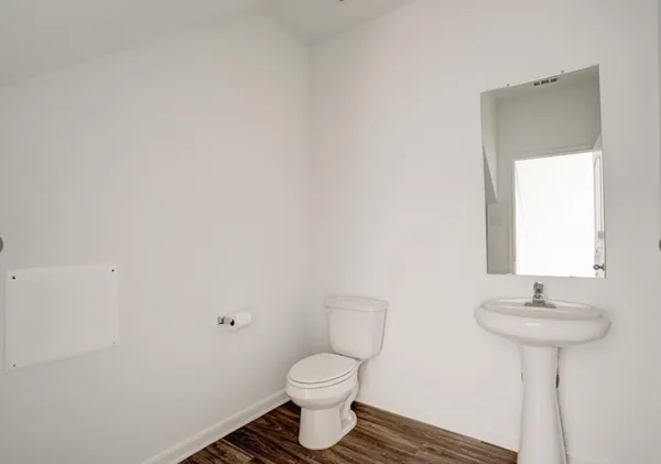 a bathroom with a sink toilet and a mirror