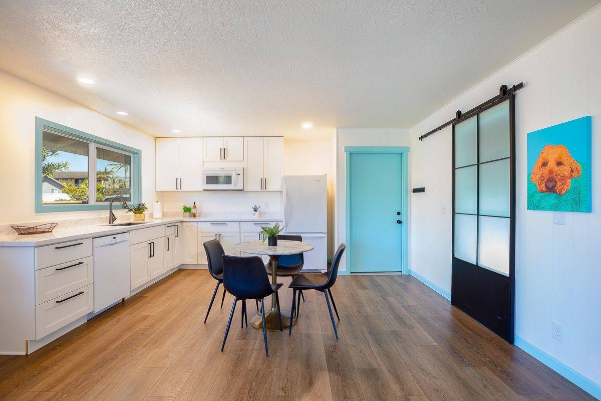 68-1788 Auhili Loop Waikoloa, HI 96738 - Photo 11 of 29 a kitchen with white cabinets and stainless steel appliances