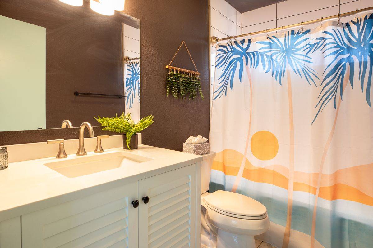 68-1788 Auhili Loop Waikoloa, HI 96738 - Photo 14 of 29 a bathroom with a sink a toilet and a mirror