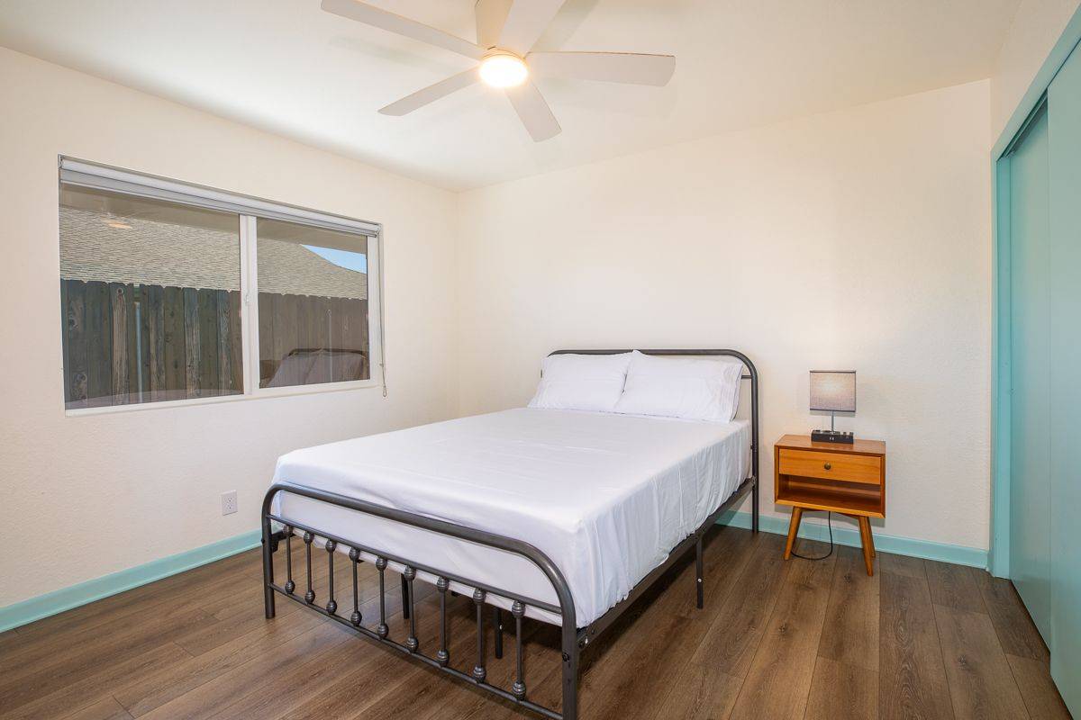 68-1788 Auhili Loop Waikoloa, HI 96738 - Photo 21 of 29 a bedroom with a bed and a window