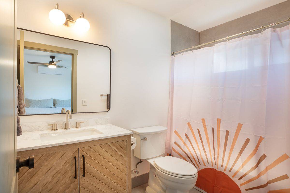 68-1788 Auhili Loop Waikoloa, HI 96738 - Photo 27 of 29 a bathroom with a sink a toilet and shower