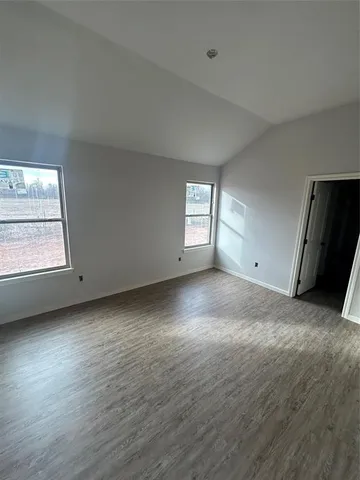 a kitchen with a stove and white cabinets