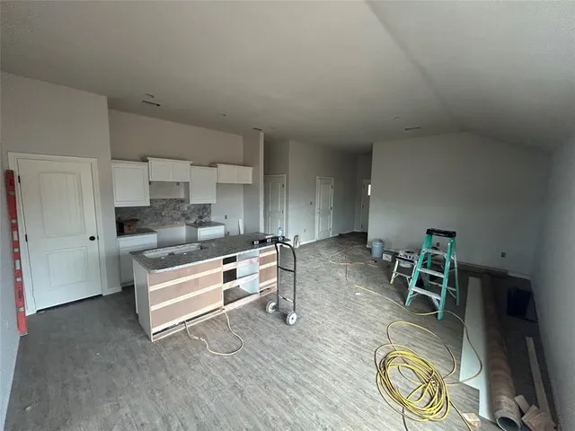 a kitchen with a table and chairs in it