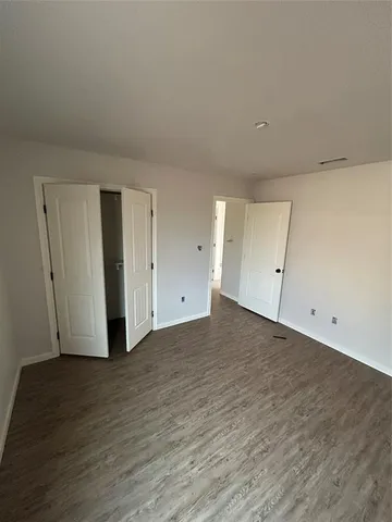 a view of an empty room and wooden floor
