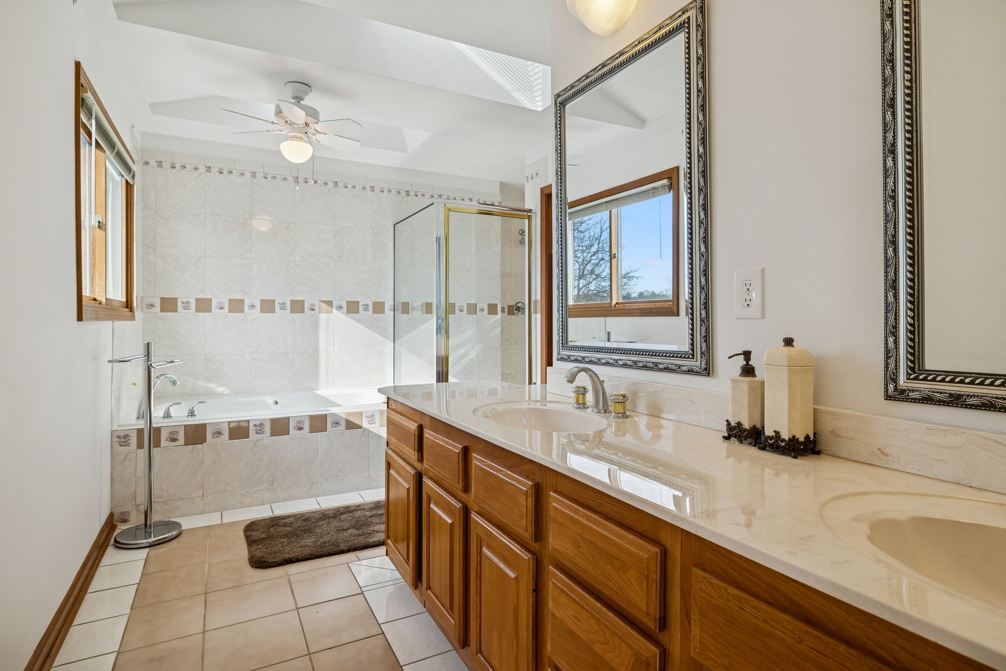 1795 Needmore Road Old Hickory, TN 37138 - Photo 21 of 56 a bathroom with a double vanity sink a mirror and a bathtub