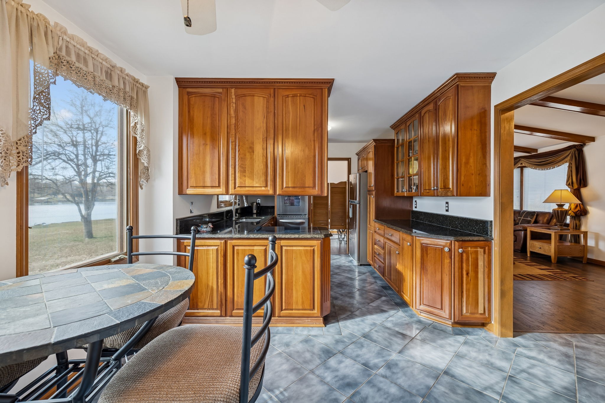 1795 Needmore Road Old Hickory, TN 37138 - Photo 6 of 56 a kitchen with stainless steel appliances granite countertop a stove a sink and a refrigerator