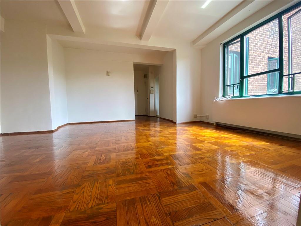 1561 Unionport Road, Unit 5G Bronx, NY 10462 - Photo 1 of 1 a view of an empty room with wooden floor and a window