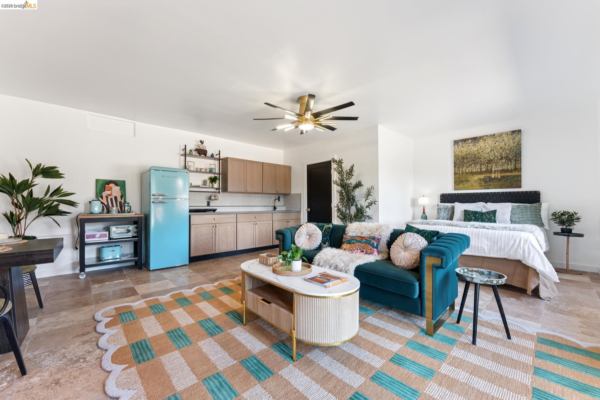 2301 Oak Street Berkeley, CA 94708 - Photo 55 of 61 Open-concept living space featuring light-toned tile flooring, a kitchenette with wood cabinetry and a light-colored countertop, and a ceiling fan with integrated lighting