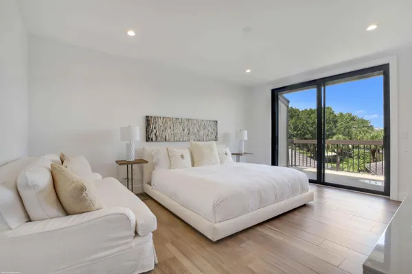 a bedroom with a large bed and a large window