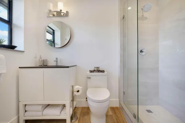 a bathroom with a toilet a sink and mirror