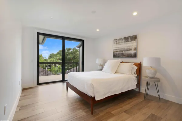 a bedroom with a large bed and a large window