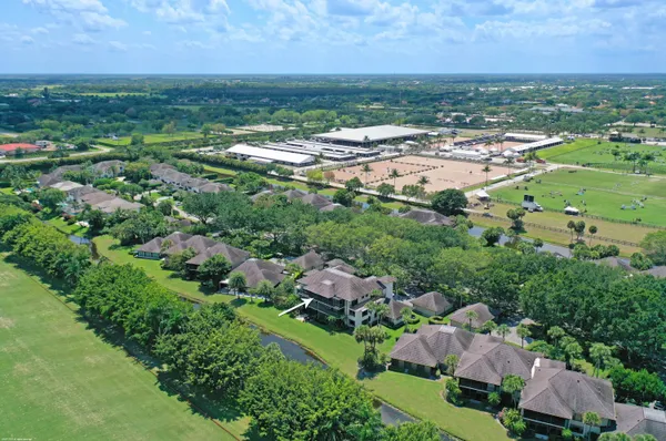 an aerial view of residential houses with outdoor space and trees