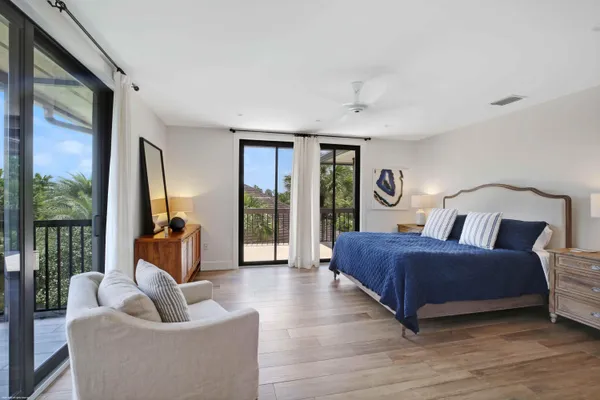 a bedroom with a bed and glass window
