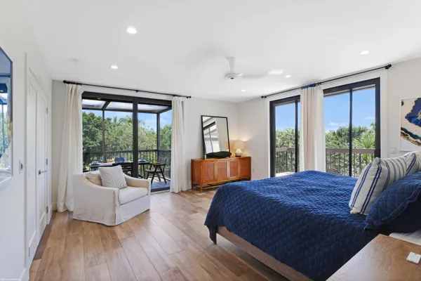 a spacious bedroom with a large bed and a large window