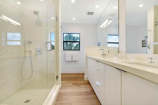 a bathroom with a granite countertop sink a shower and a mirror