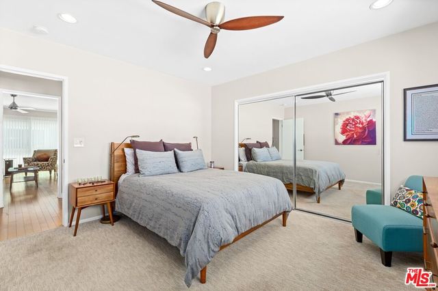 a bedroom with bed and a chandelier