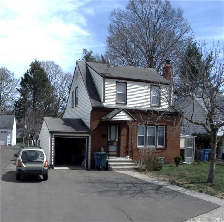 a view of a car parked in front of a brick house
