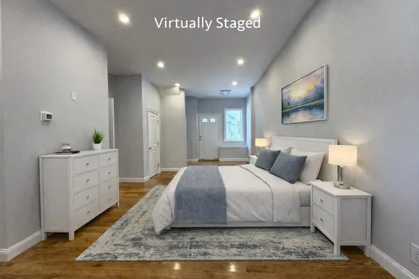 a spacious bedroom with a bed and a dresser