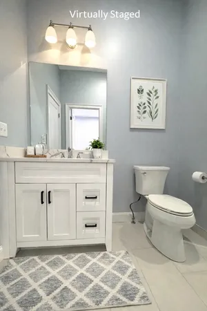 a bathroom with a sink mirror and a toilet