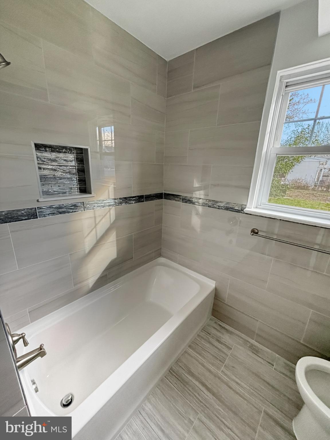 705 2nd Street Delanco, NJ 08075 - Photo 11 of 16 a bathroom with a bathtub and a window