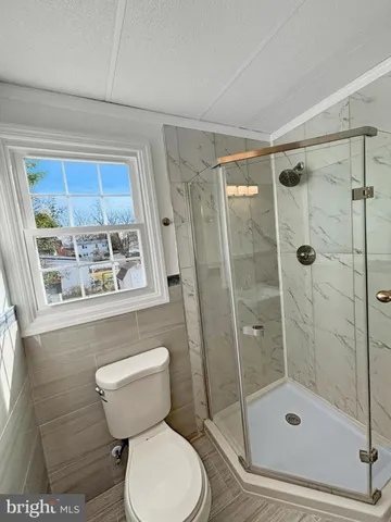 a bathroom with a toilet and a shower