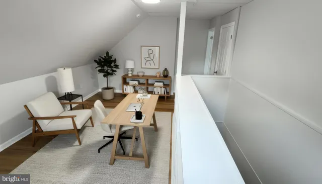 a living room with chairs and a table