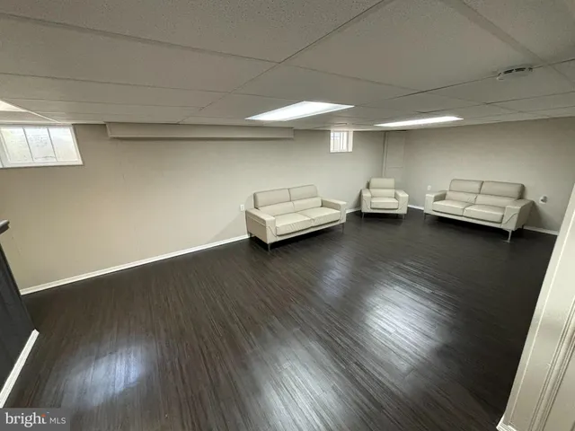 a view of a room with wooden floor and furniture