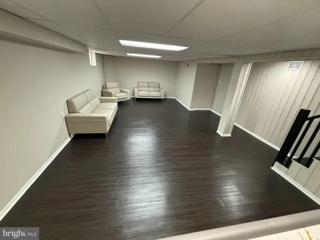 a view of an empty room and wooden floor