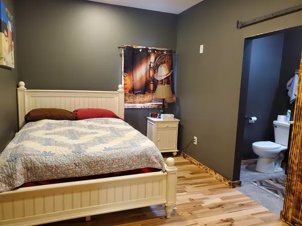 a bedroom with a bed and a mirror