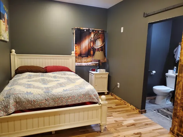 a bedroom with a bed and a mirror