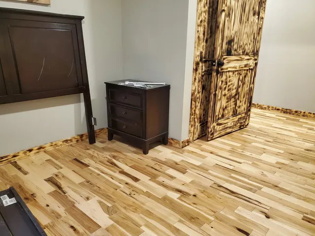 a bed sitting in a bedroom next to a cabinet