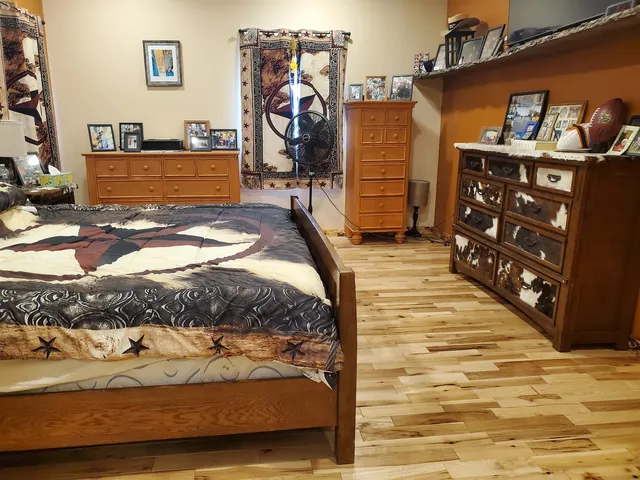 a kitchen with stainless steel appliances kitchen island granite countertop a sink refrigerator and cabinets