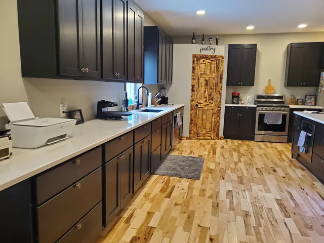 a kitchen with stainless steel appliances granite countertop a refrigerator stove and sink