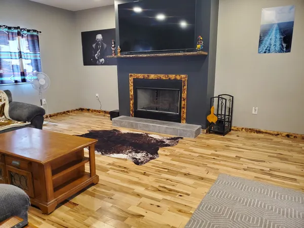 a living room with stainless steel appliances kitchen island granite countertop a dining table chairs and a oven