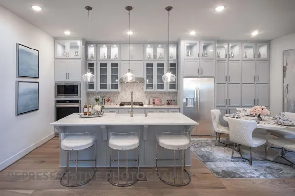 a large kitchen with a table and chairs