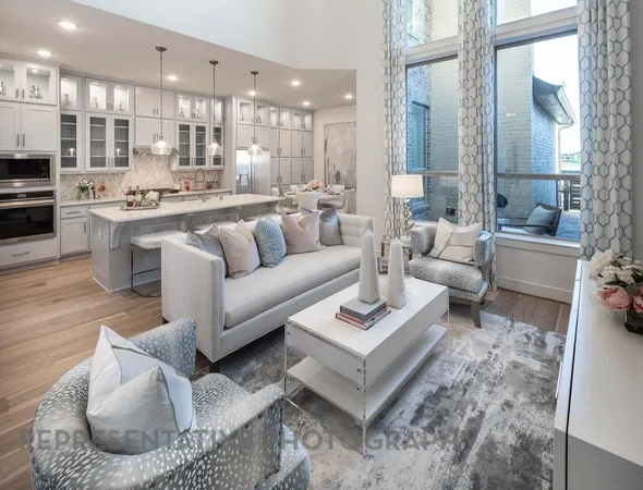a living room with furniture kitchen view and a large window