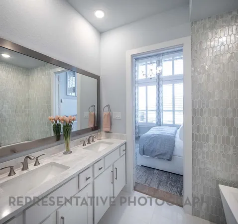 a spacious bathroom with double vanity and a mirror