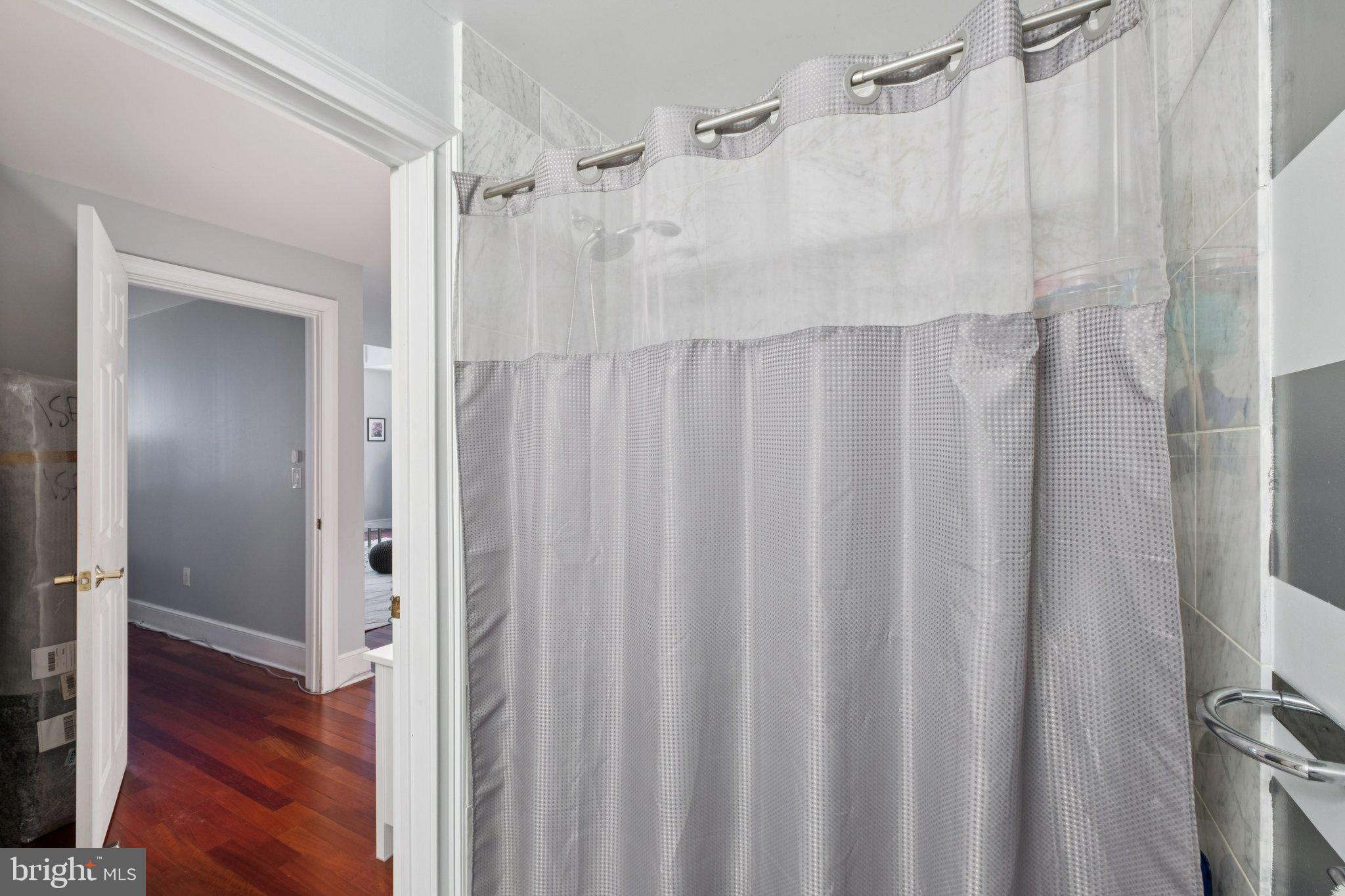 1500 Chestnut Street, Unit 15E Philadelphia, PA 19102 - Photo 4 of 5 a bathroom with a shower and a tub