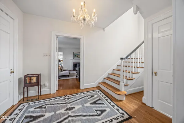 a view of a bedroom with wooden floor and staircase