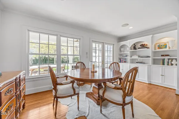 a view of a dining room with furniture a rug and wooden floor