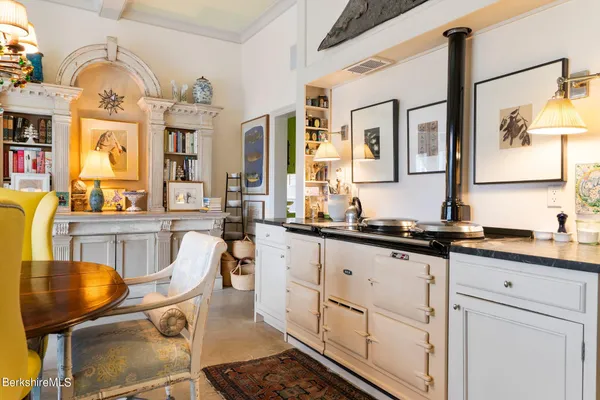 a living room with furniture book shelf and a book shelf
