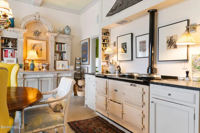 a living room with furniture book shelf and a book shelf
