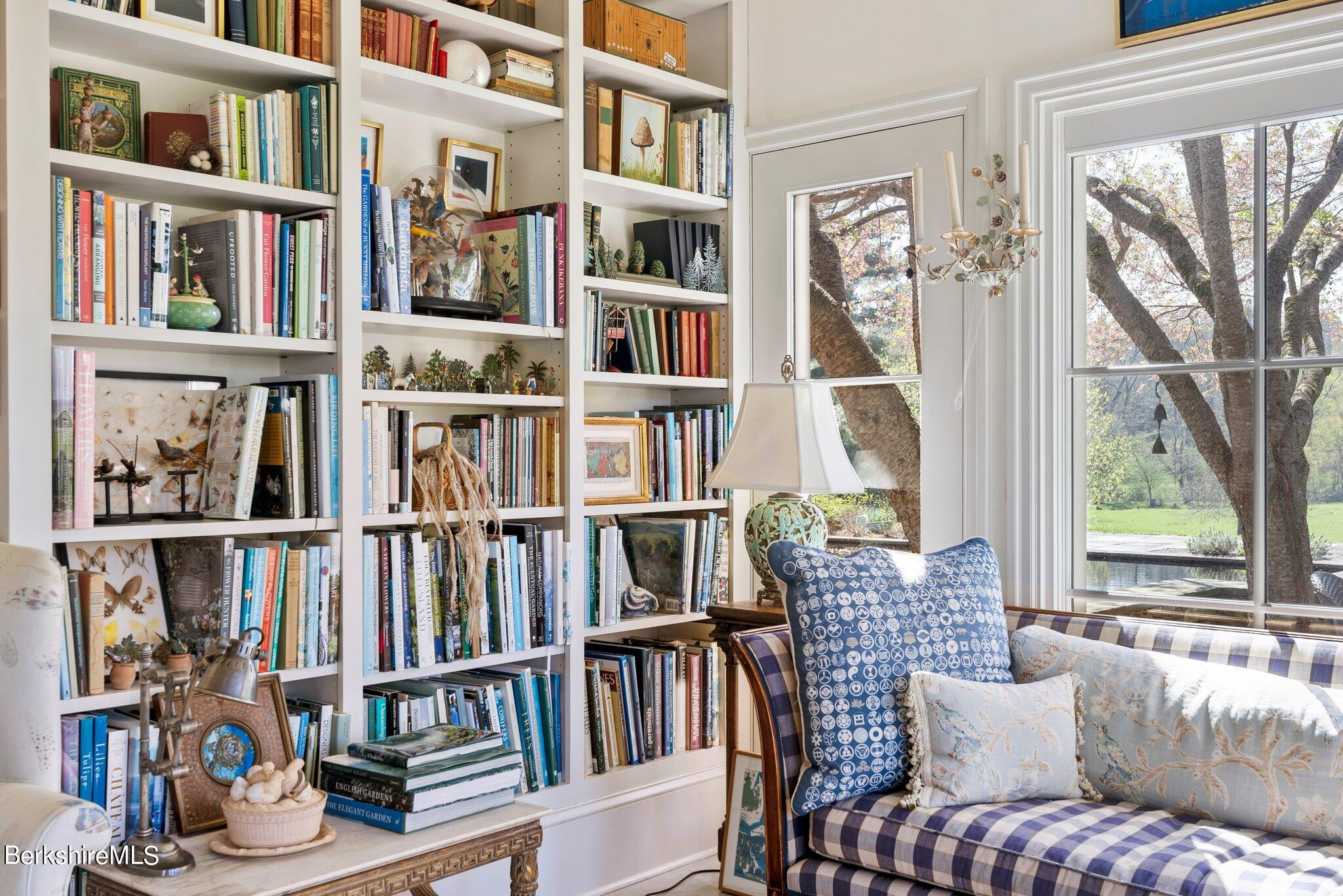 77 Seekonk Cross Road Great Barrington, MA 01230 - Photo 17 of 66 a living room with furniture book shelf and a book shelf